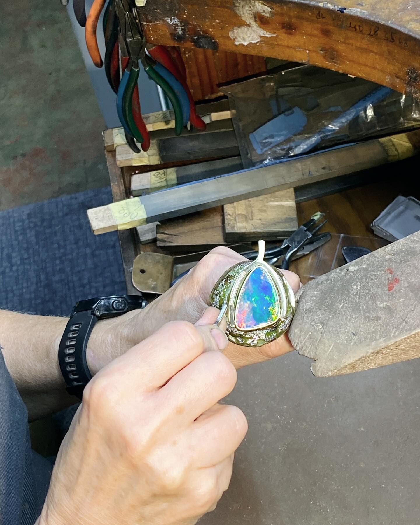 Jeweler's Hands Working on an Opal Pendant — Regency Jewellers in Cairns City, QLD