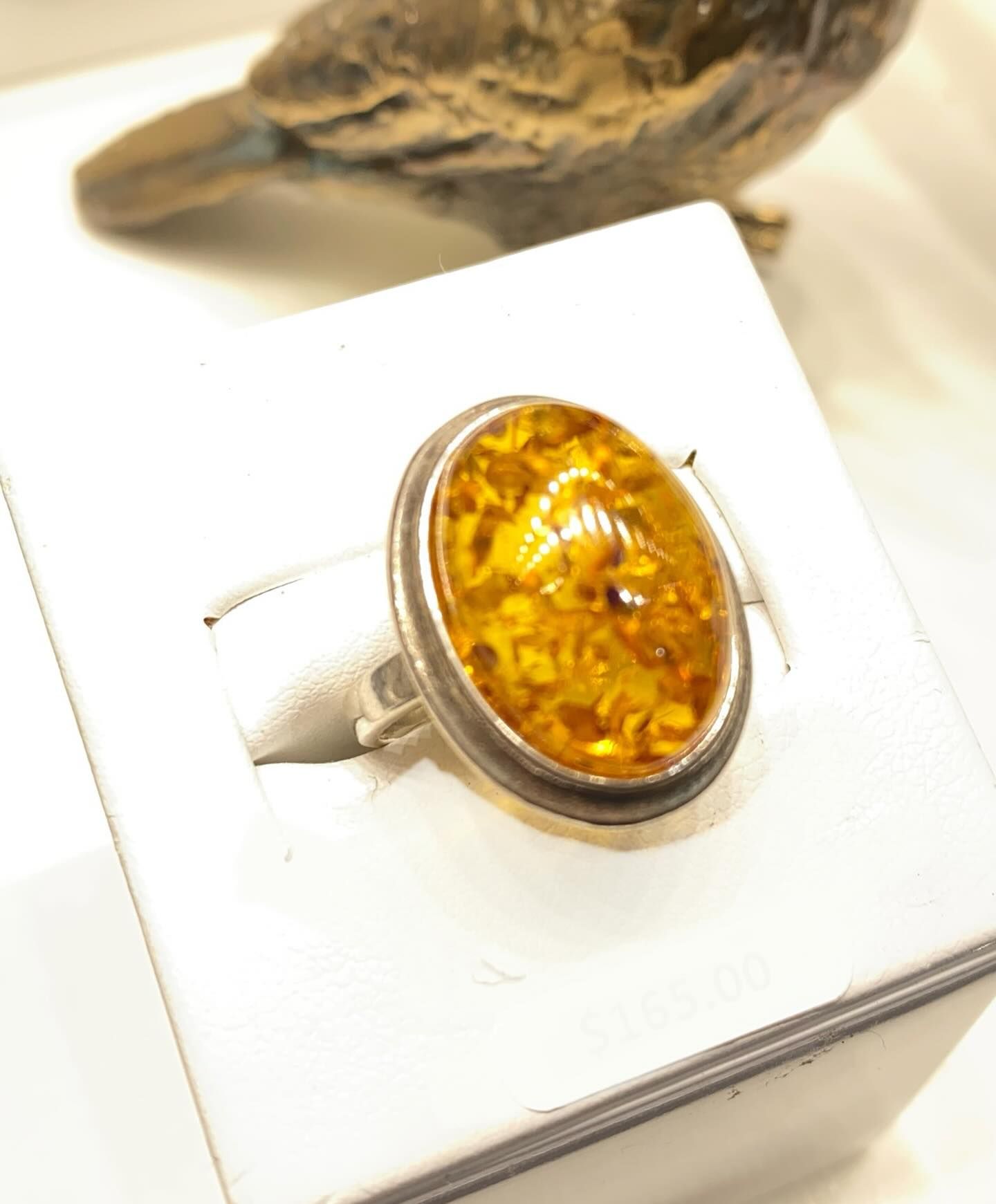 Silver Ring With Oval Amber Stone, on a White Display — Regency Jewellers in Cairns City, QLD
