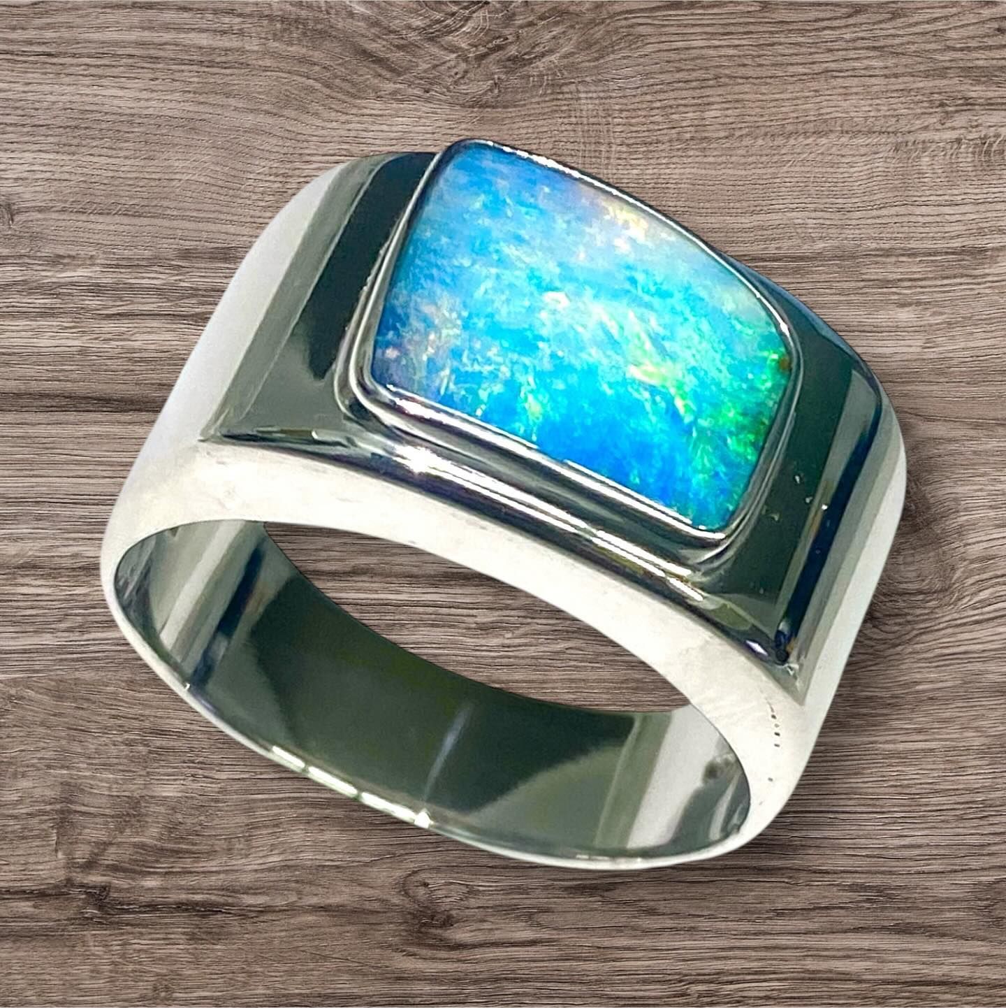 Silver Ring With Large Opal Gemstone, Displaying Blue and Green Fire — Regency Jewellers in Cairns City, QLD