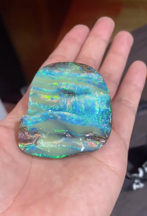 Colorful Gemstones Scattered on a Rough, Textured Surface — Regency Jewellers in Cairns City, QLD