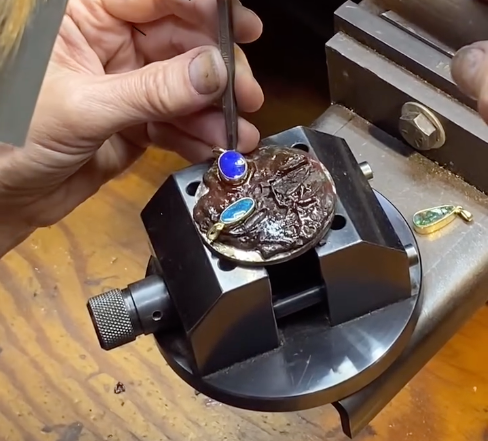 Jeweler Examines a Necklace With a Magnifying Visor Under a Desk Lamp — Regency Jewellers in Cairns City, QLD