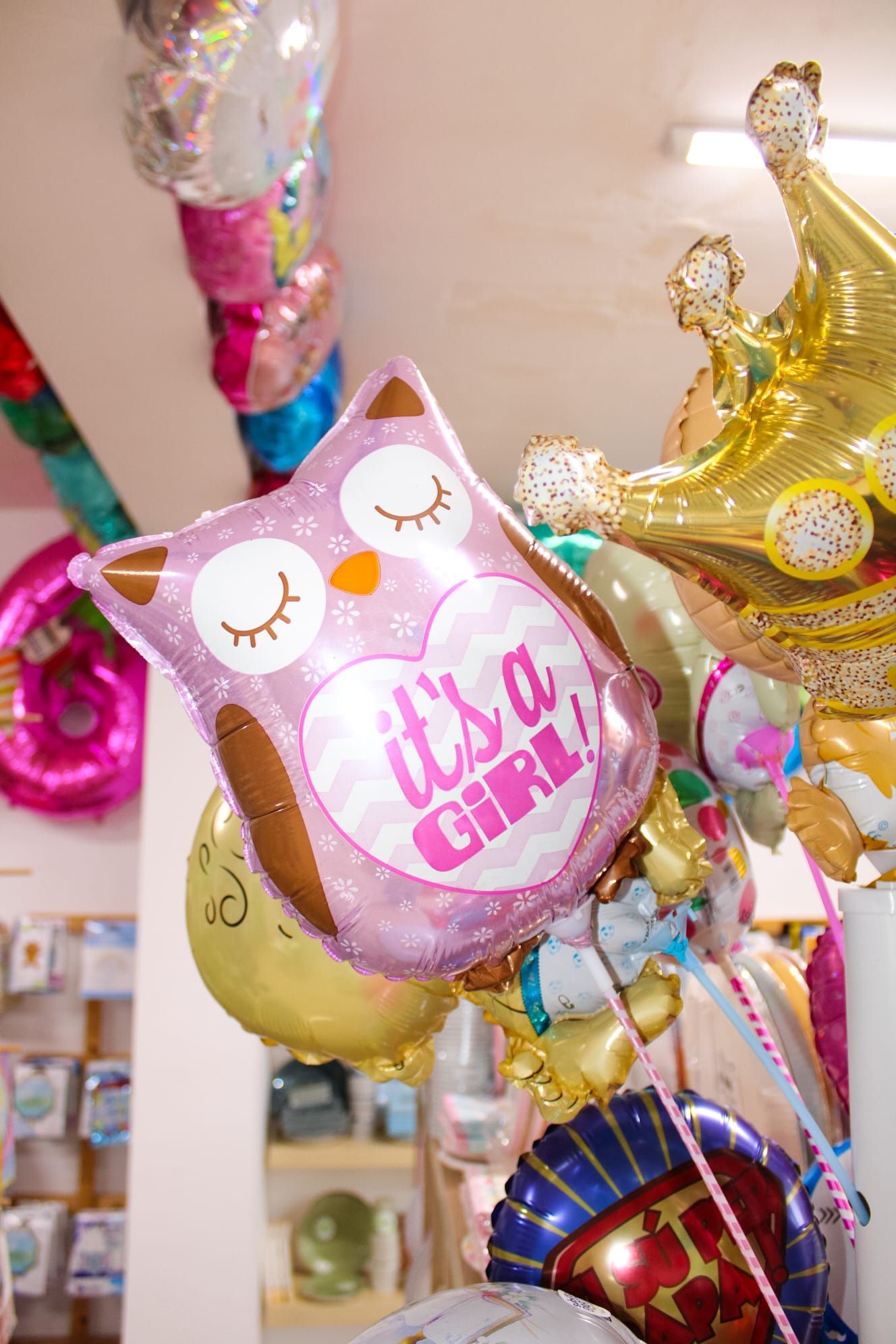 Un mazzo di palloncini pende dal soffitto e su uno di essi c'è scritto ``è una femmina''.