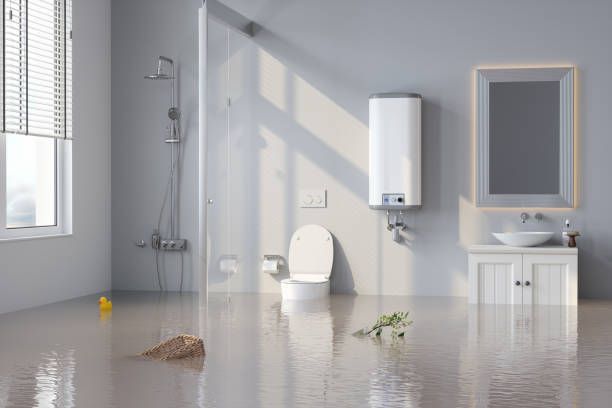 A flooded bathroom with a toilet, sink, and floating objects.