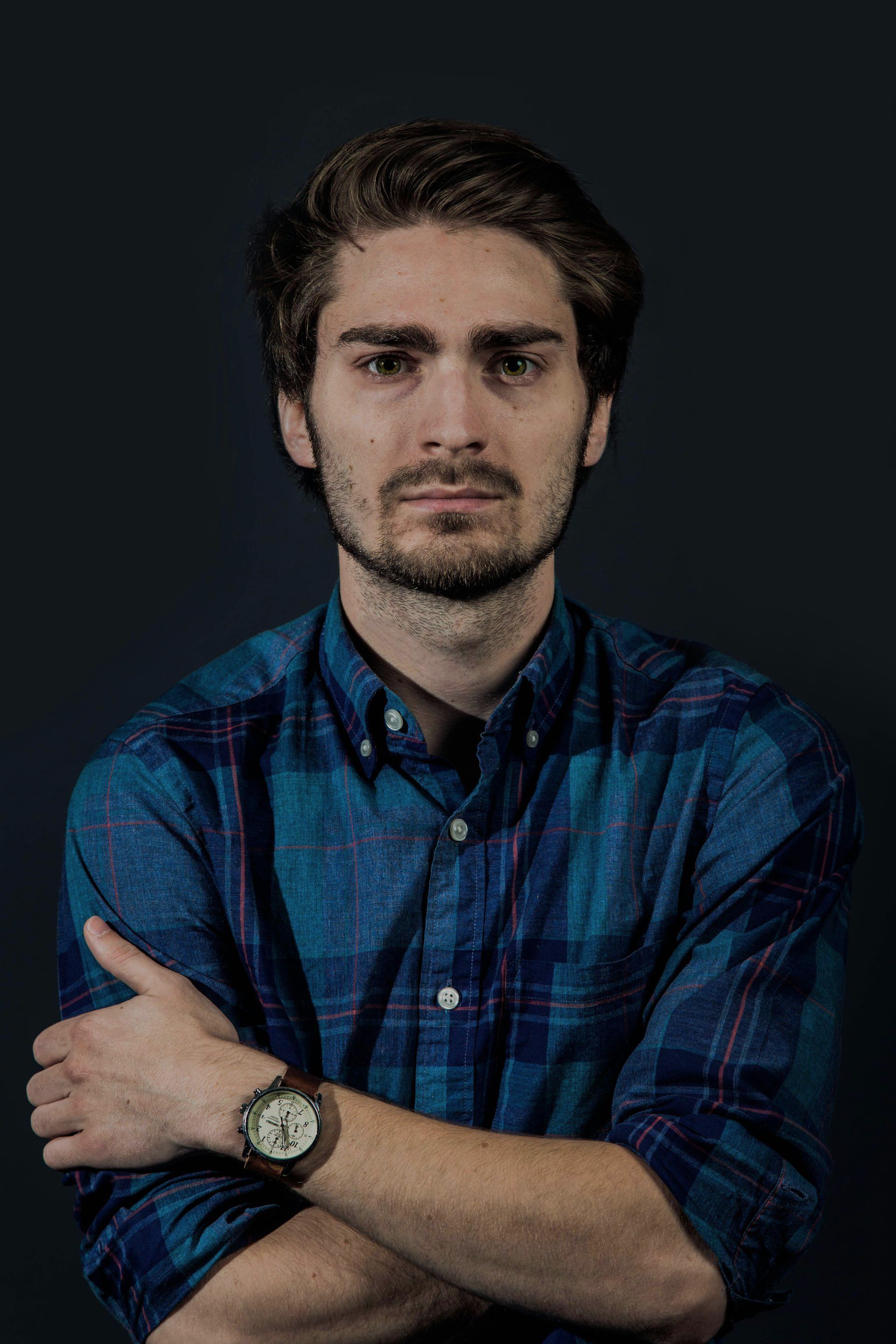 A man with his arms crossed wearing a watch