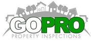 A logo for gopro property inspections with houses and trees in the background.