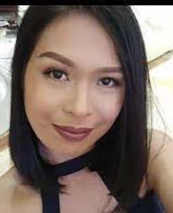 A close up of a woman 's face wearing a choker.