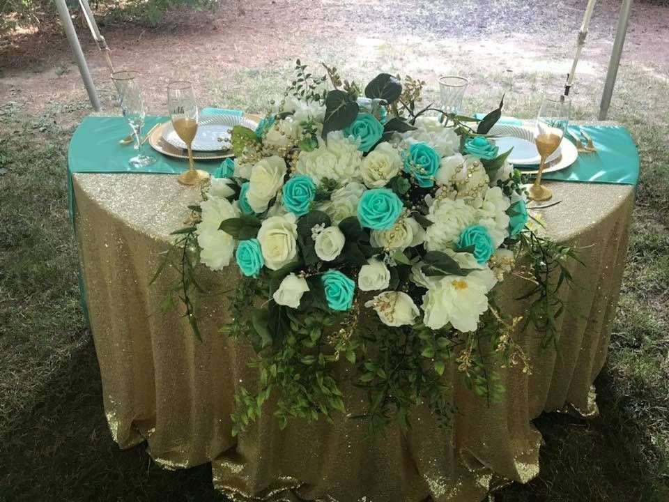 A table with a tablecloth and flowers on it.