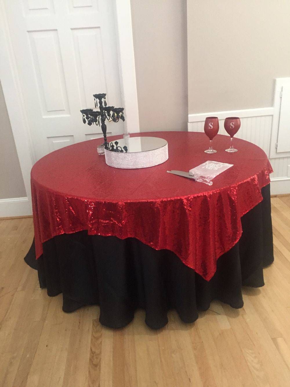 A round table with a red and black table cloth