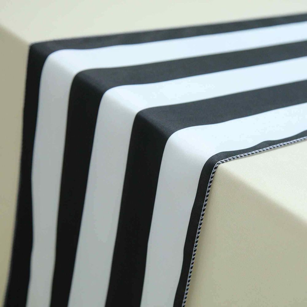 A black and white striped table runner is on a table