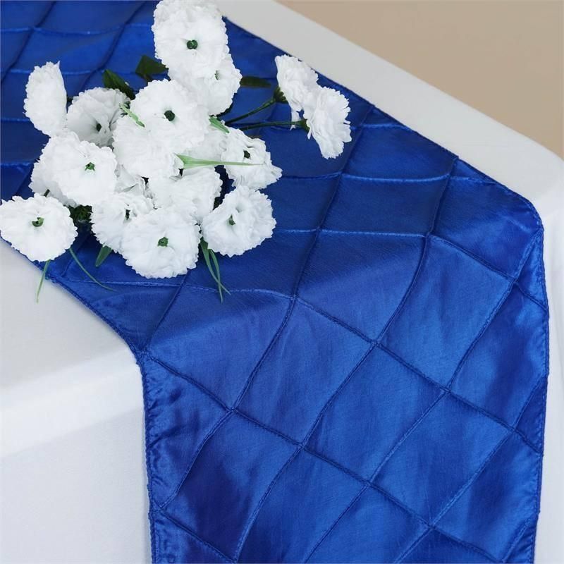 A blue table runner with white flowers on it