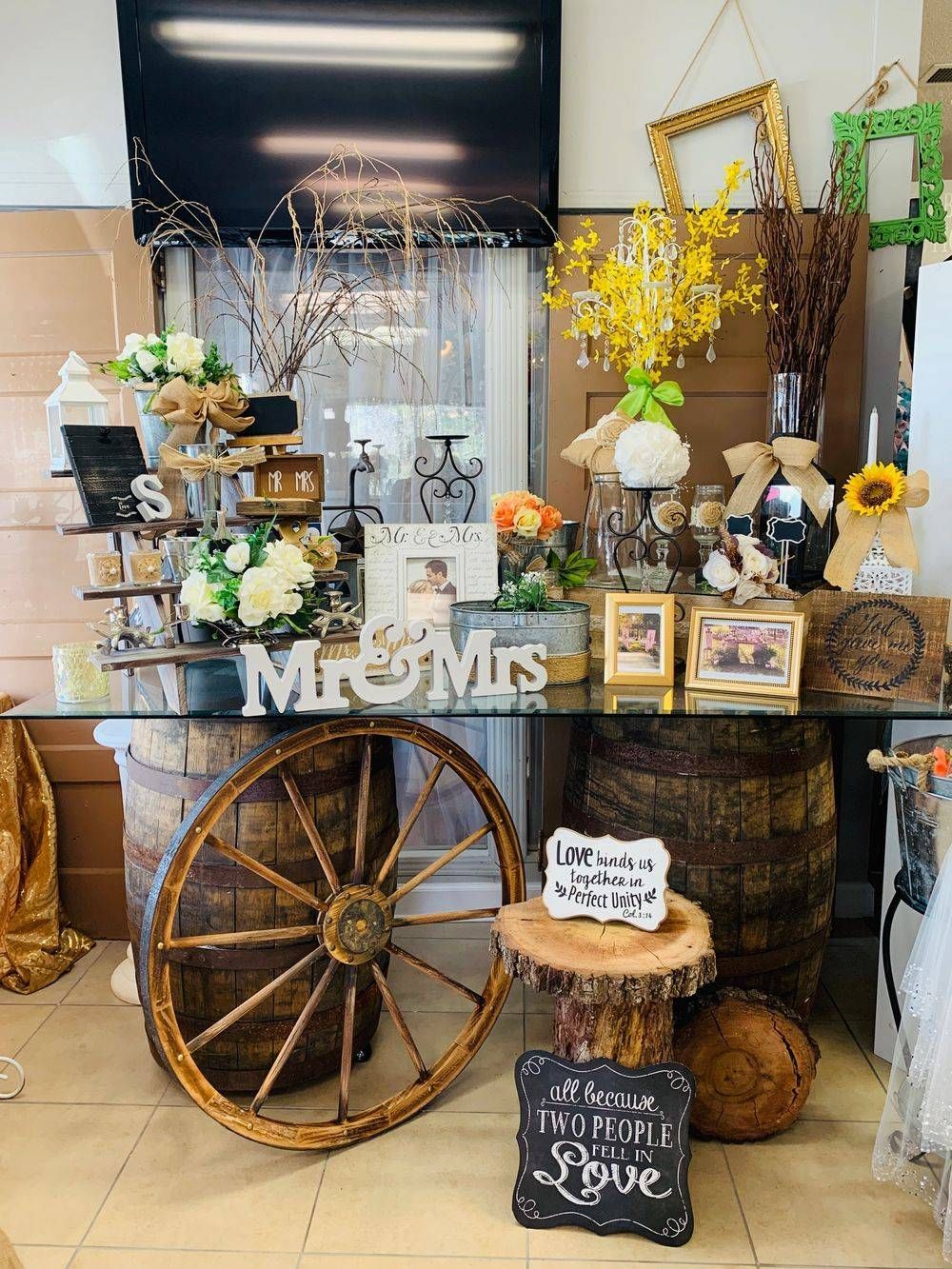 A table with a wagon wheel and a sign that says mr. and mrs.