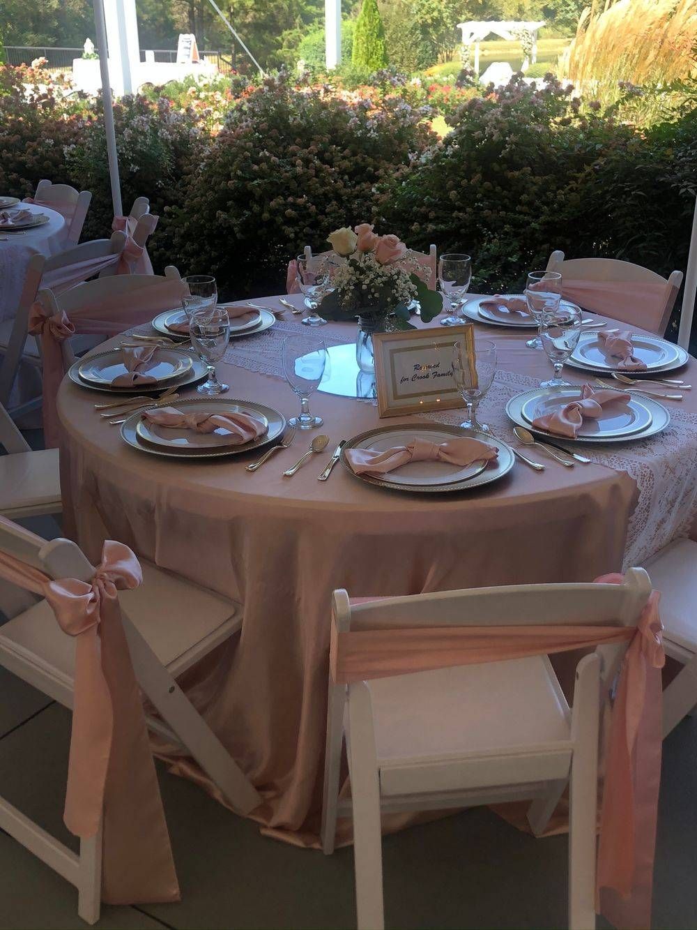 A table set for a wedding reception with plates and utensils on it.