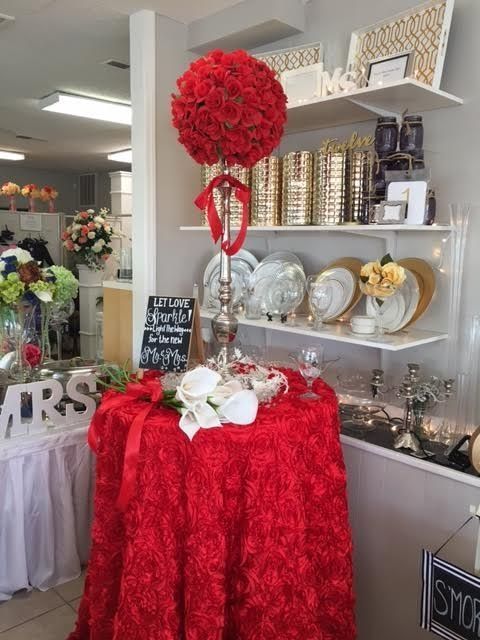 A red table cloth is on a table in a store.