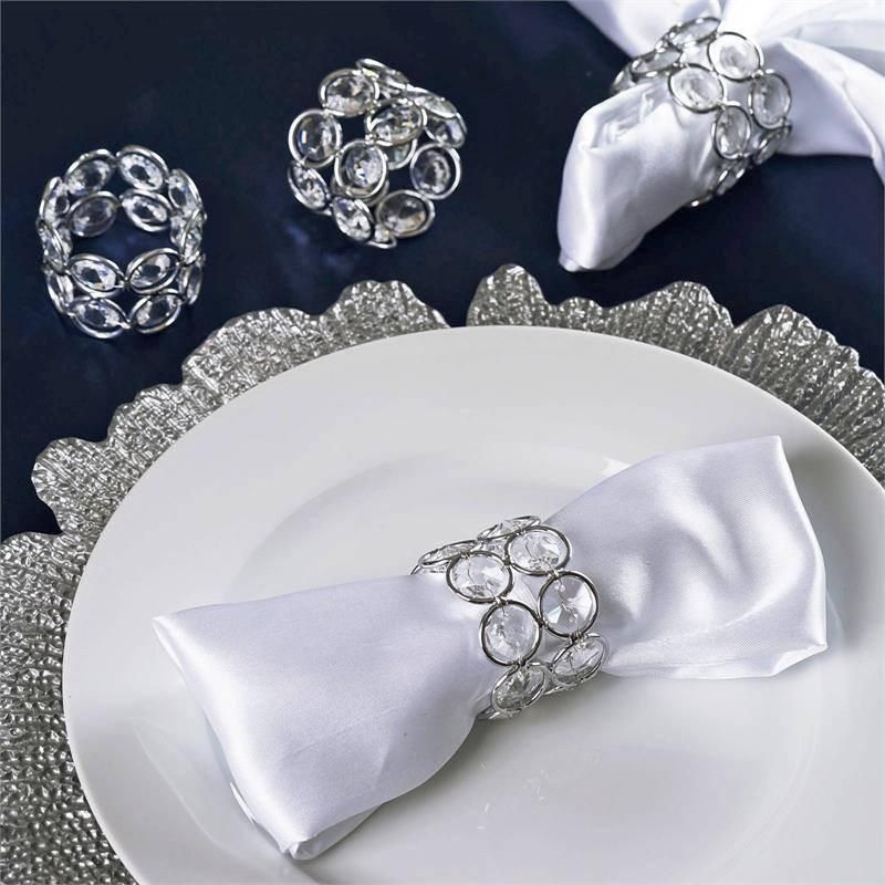 A white plate with a napkin ring on it