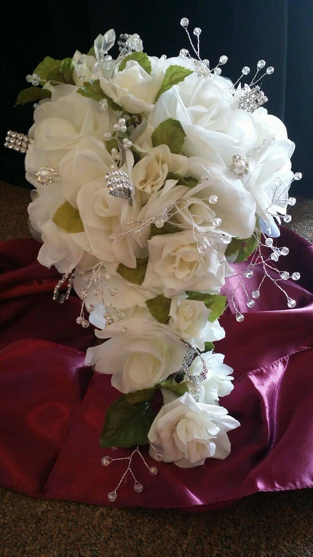 A bouquet of white flowers is sitting on a red cloth.