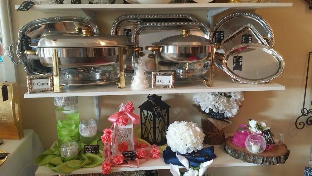 A shelf filled with a variety of serving dishes and decorations.