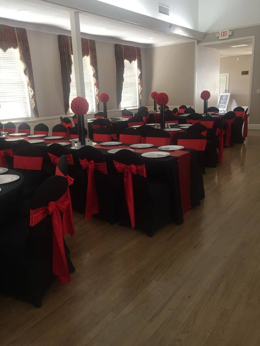 A large room with tables and chairs set up for a party.