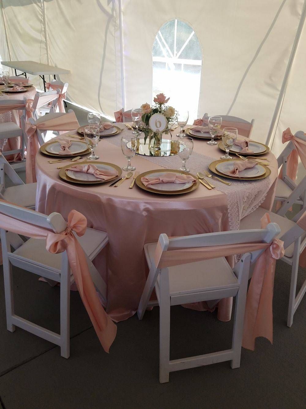A table with plates and utensils on it in a tent