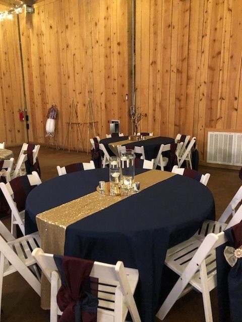 A table with a blue table cloth and a gold table runner