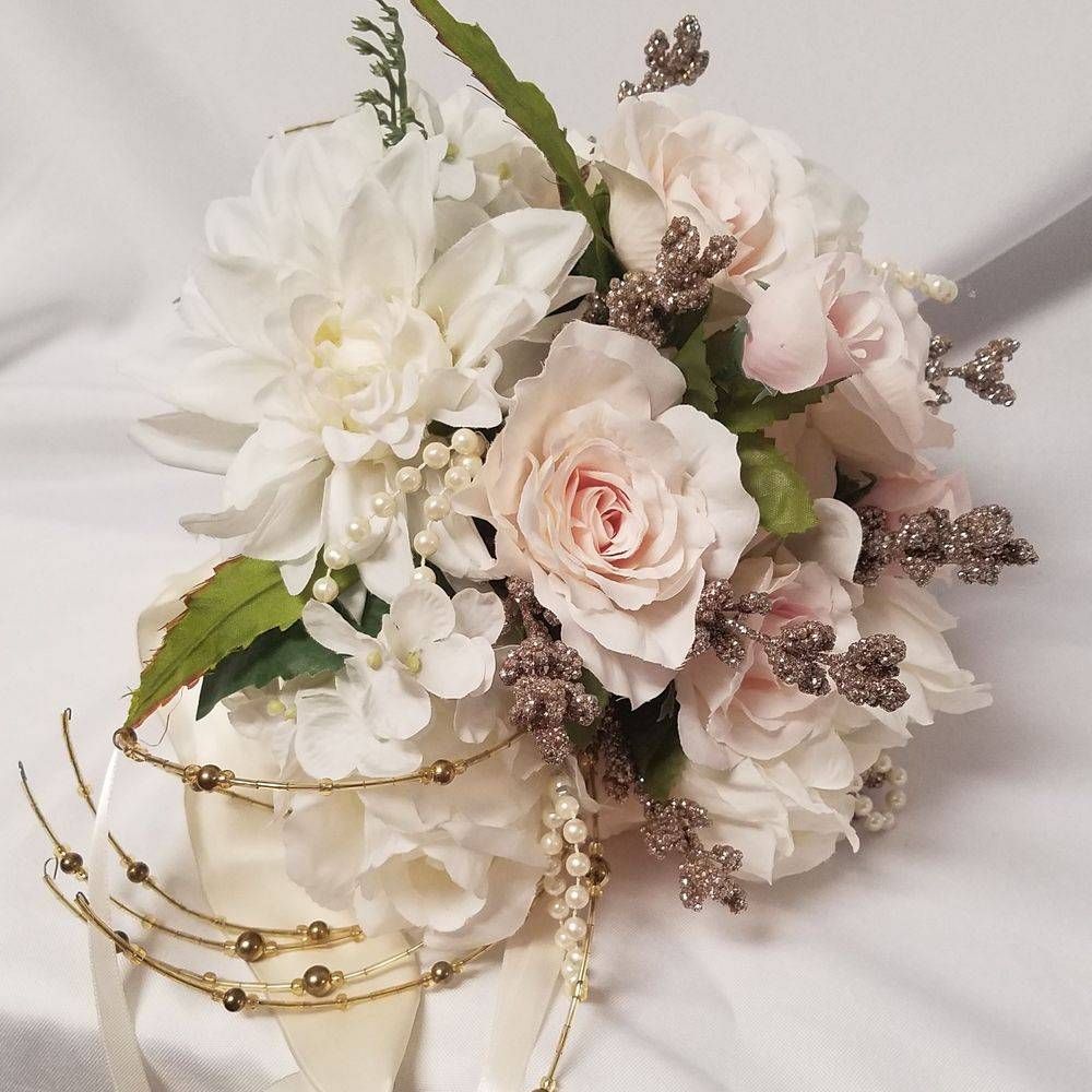 A bouquet of white flowers with pearls and ribbons