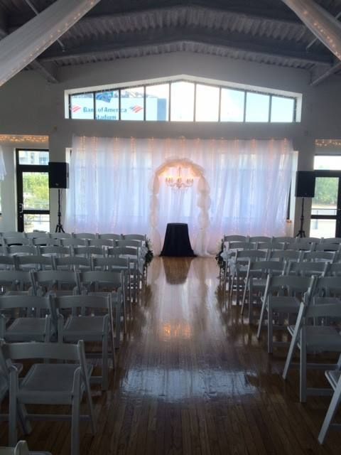 Rows of white folding chairs in a large room