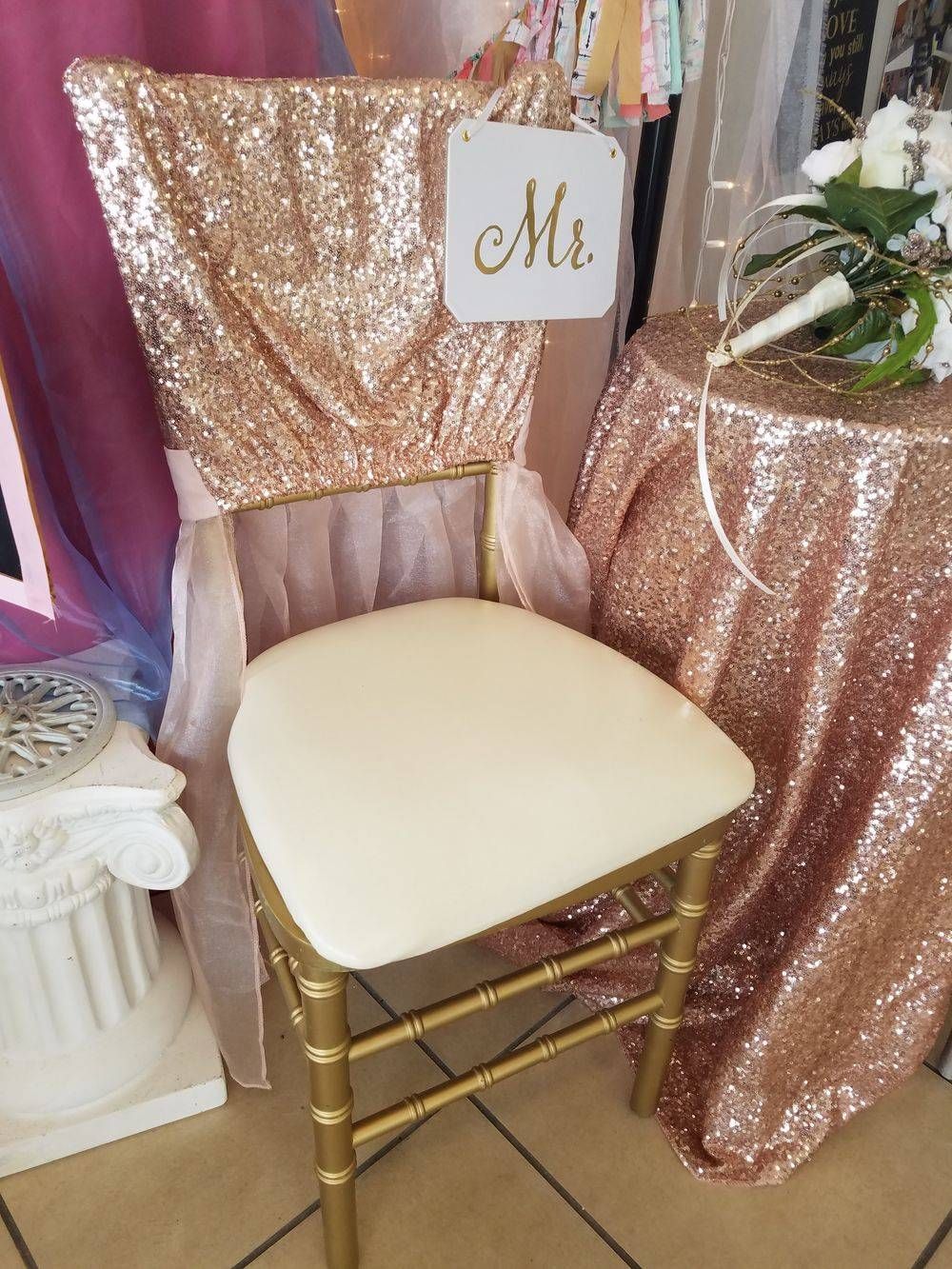 A chair with a mr. and mrs. sign on it is sitting next to a table.