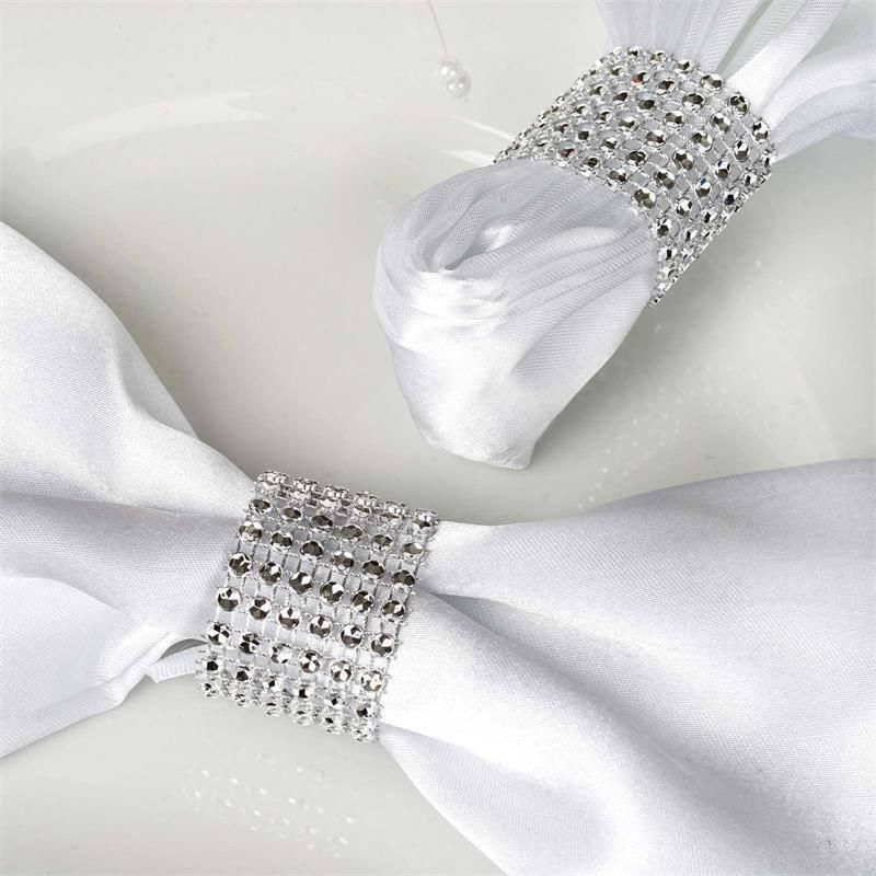 A white napkin with a silver napkin ring on it