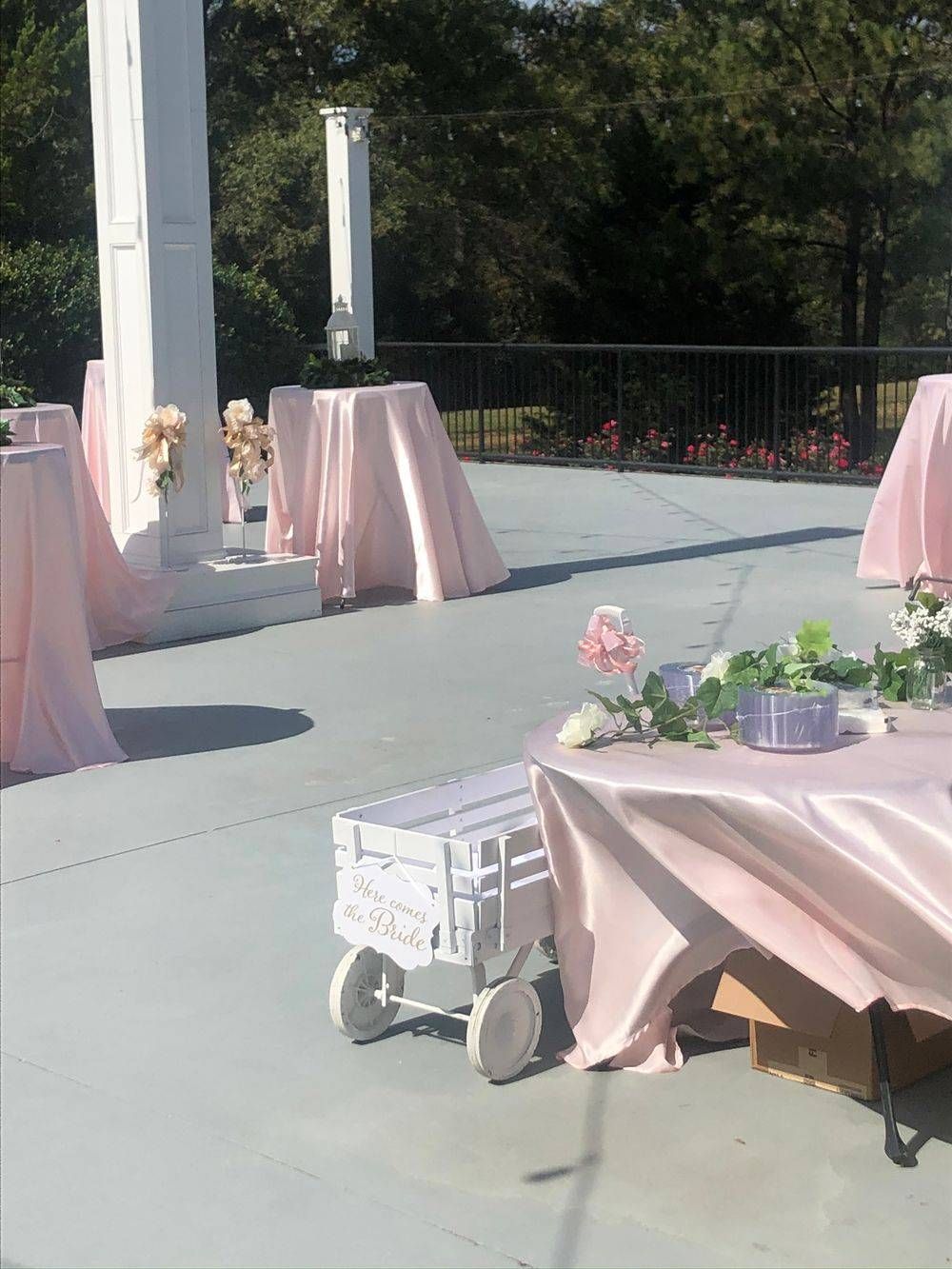 A pink table cloth is on a table outside