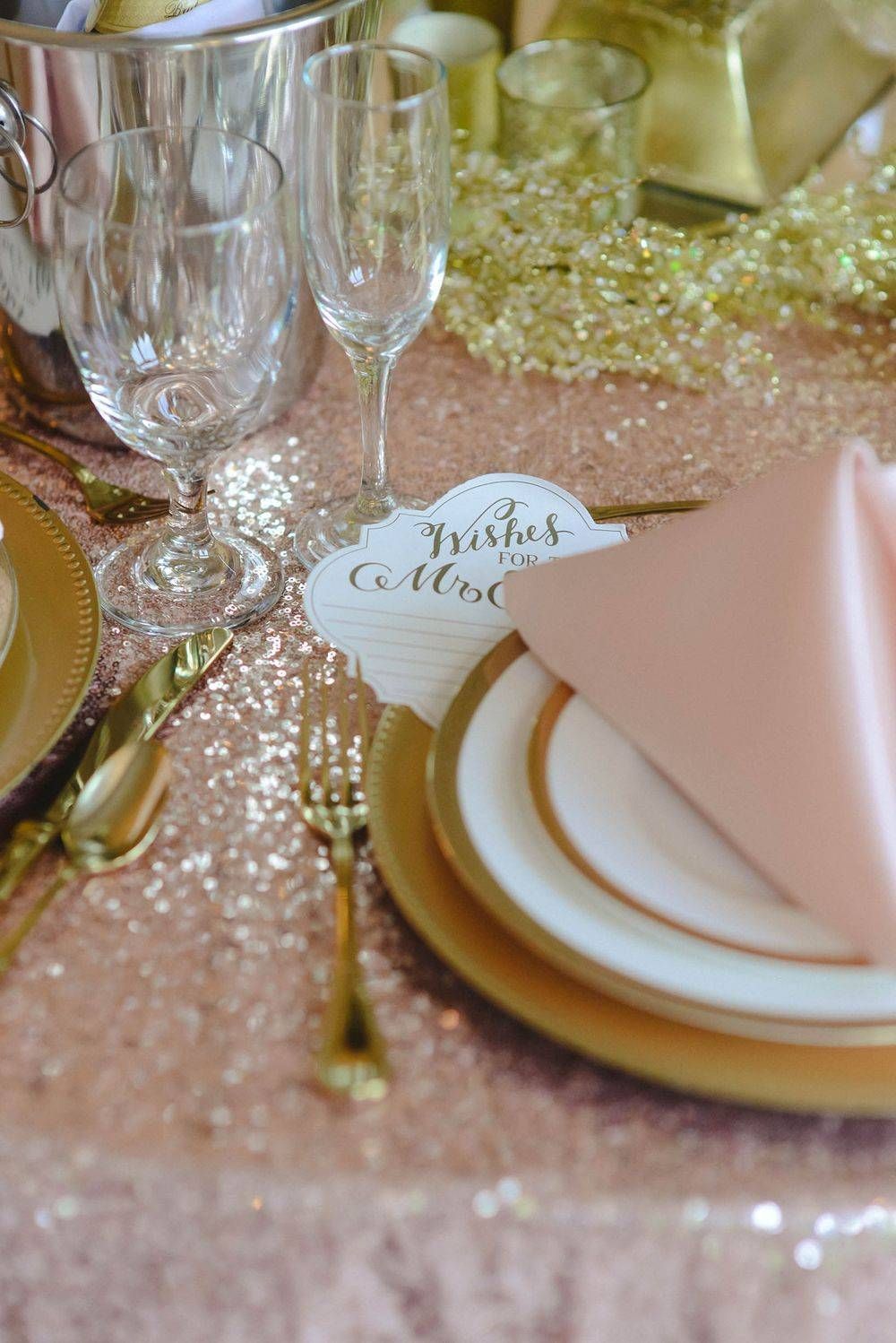 A table setting with plates , glasses , forks , knives and a napkin.
