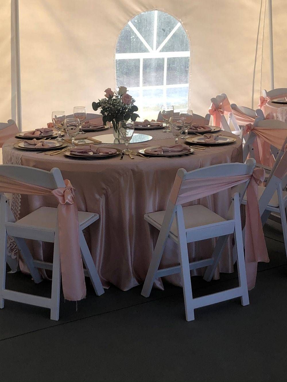 A table and chairs are set up under a tent