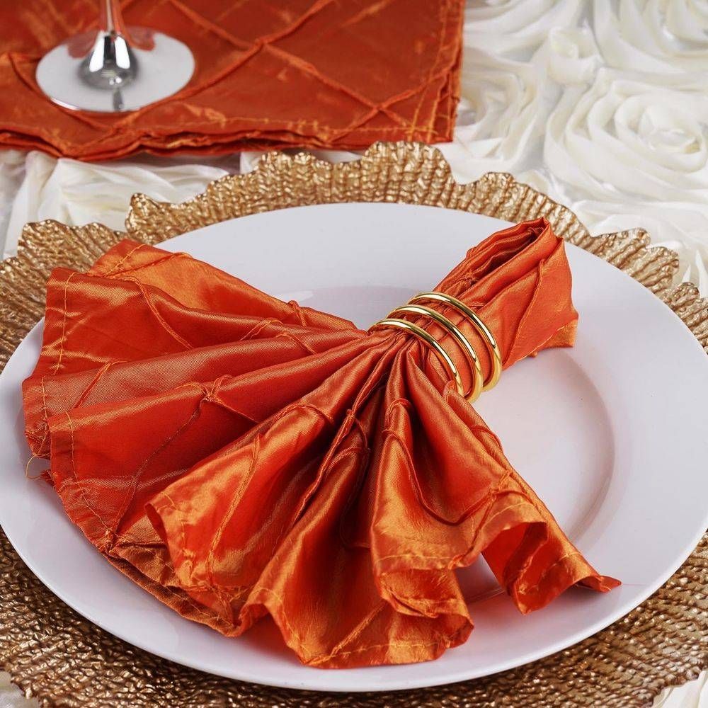 A white plate with an orange napkin on it