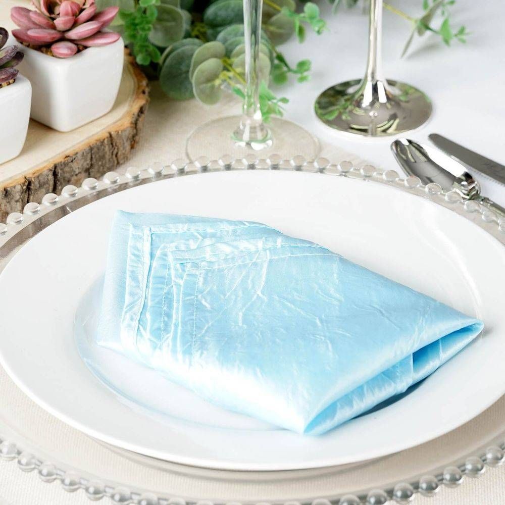 A white plate with a blue napkin on it
