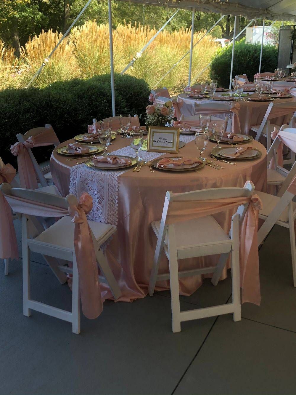 Tables and chairs are set up under a tent for a wedding reception.