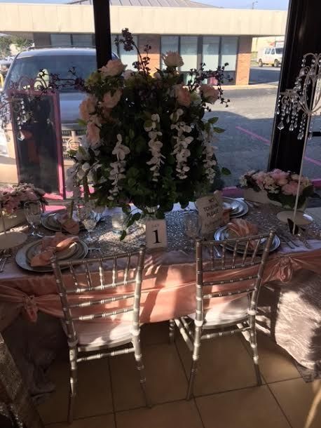 A table with a vase of flowers and a number 1 on it