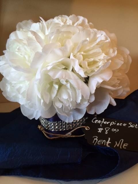 A bouquet of white flowers sits on a napkin that says