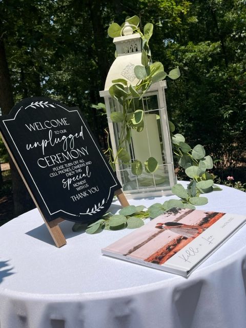 A table with a sign that says welcome unplugged ceremony special