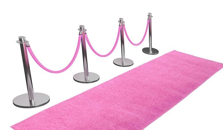 A pink carpet and rope barriers on a white background