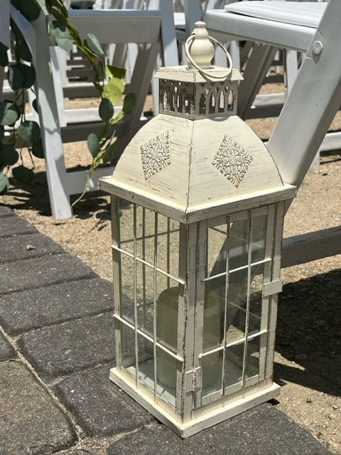 A white lantern with a candle inside of it