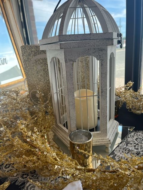 A white lantern with a candle inside of it