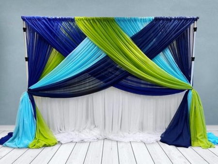 A blue green and white backdrop with blue and green curtains
