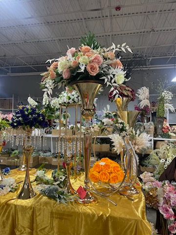 A table with a vase filled with flowers on it.