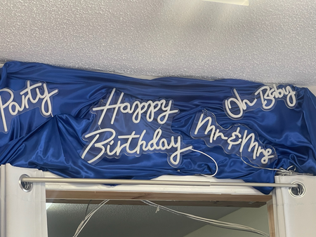 A blue cloth with the words happy birthday written on it