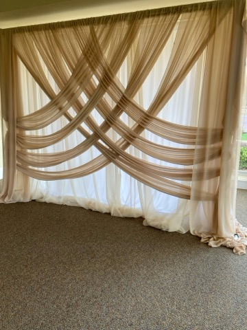 A room with a large curtain hanging on the wall.