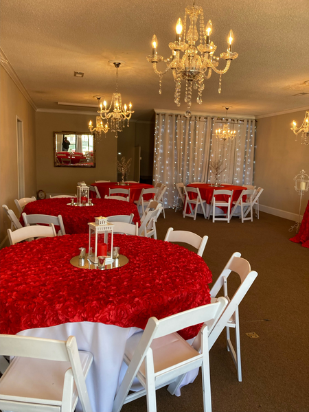 A room with red tables and white chairs