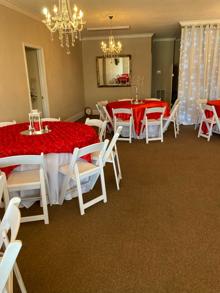 A room with red tables and white chairs