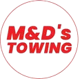 Red and white circular logo for M&D's Towing; red text on a white background.