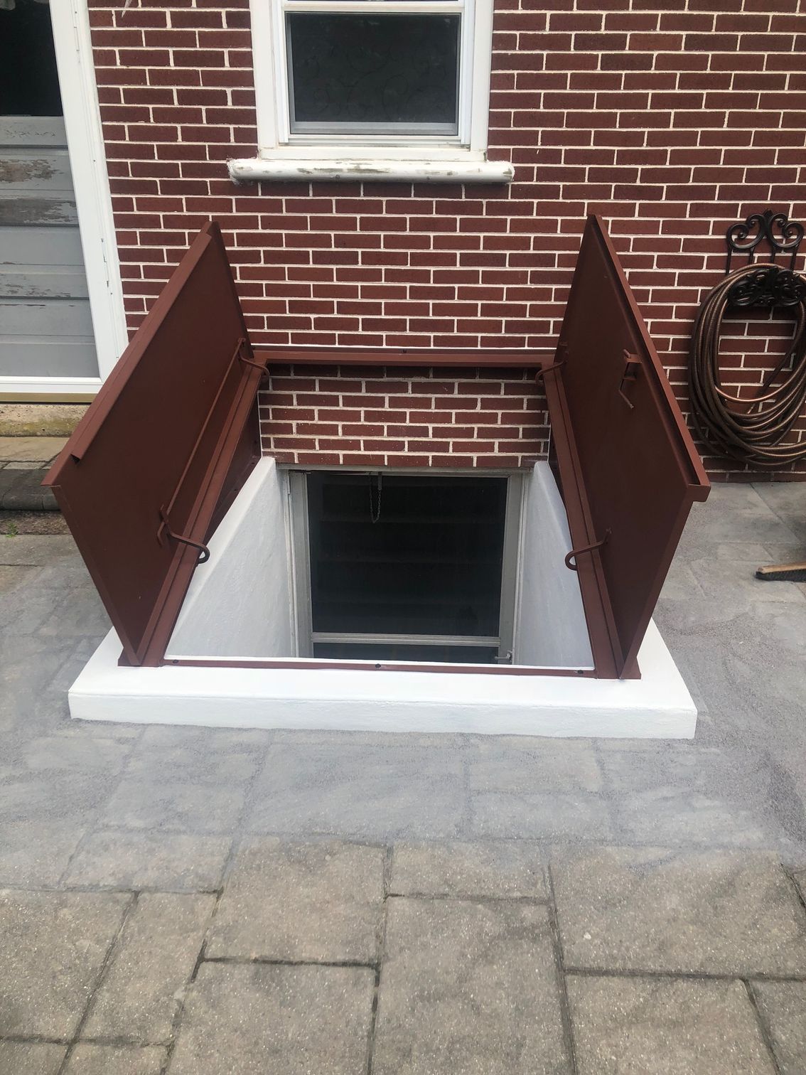 A brick wall with a window and a door in it.