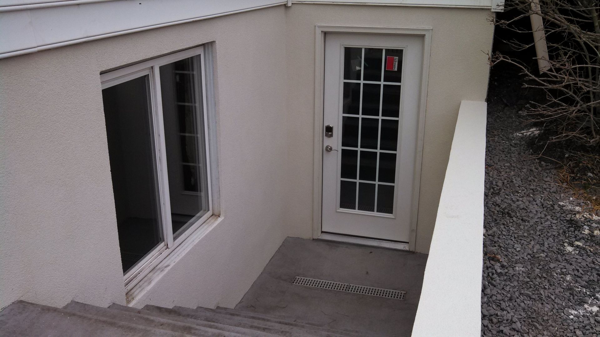 Stairs leading up to a white door with a window