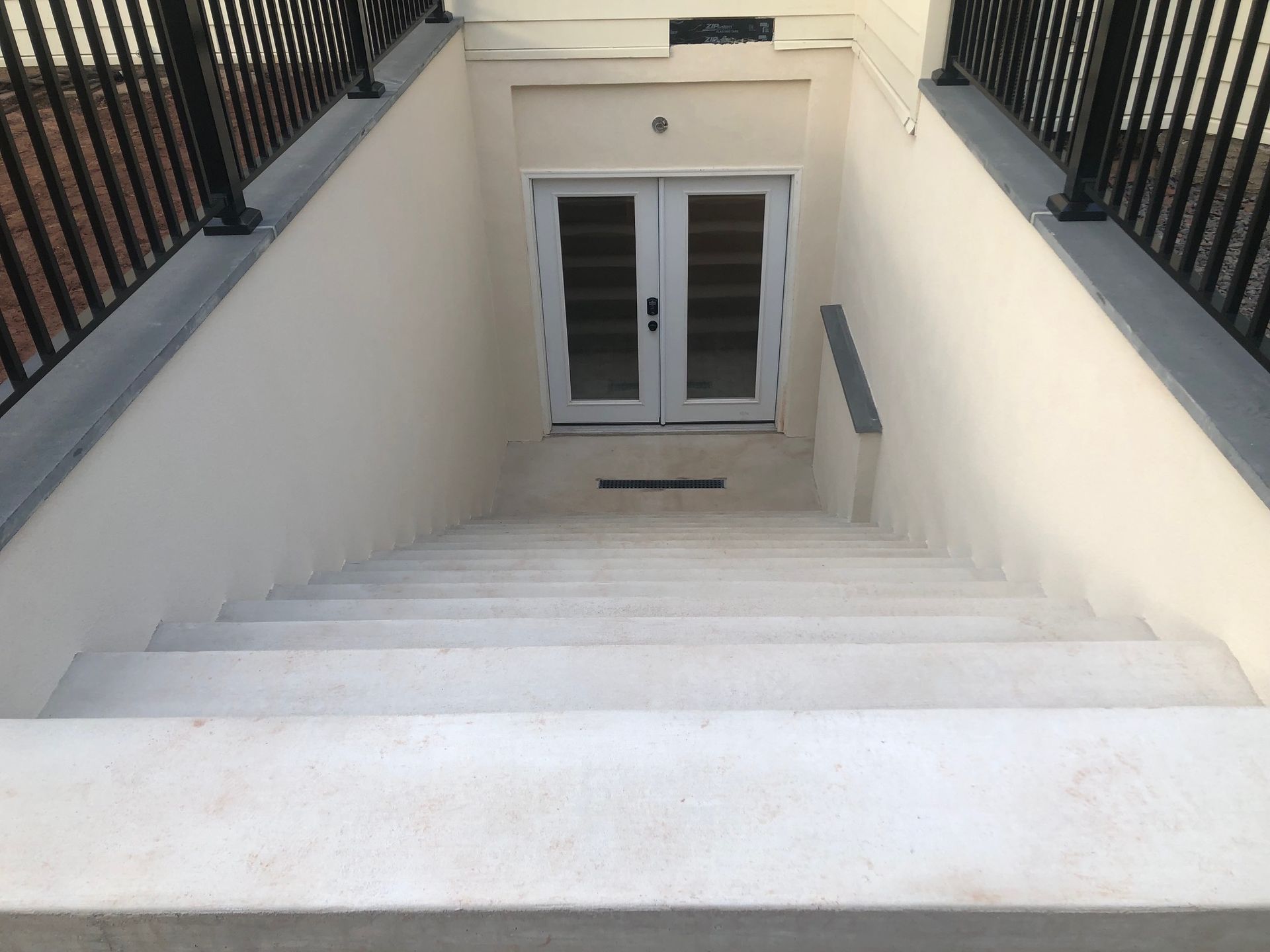 A set of stairs leading up to a doorway in a basement