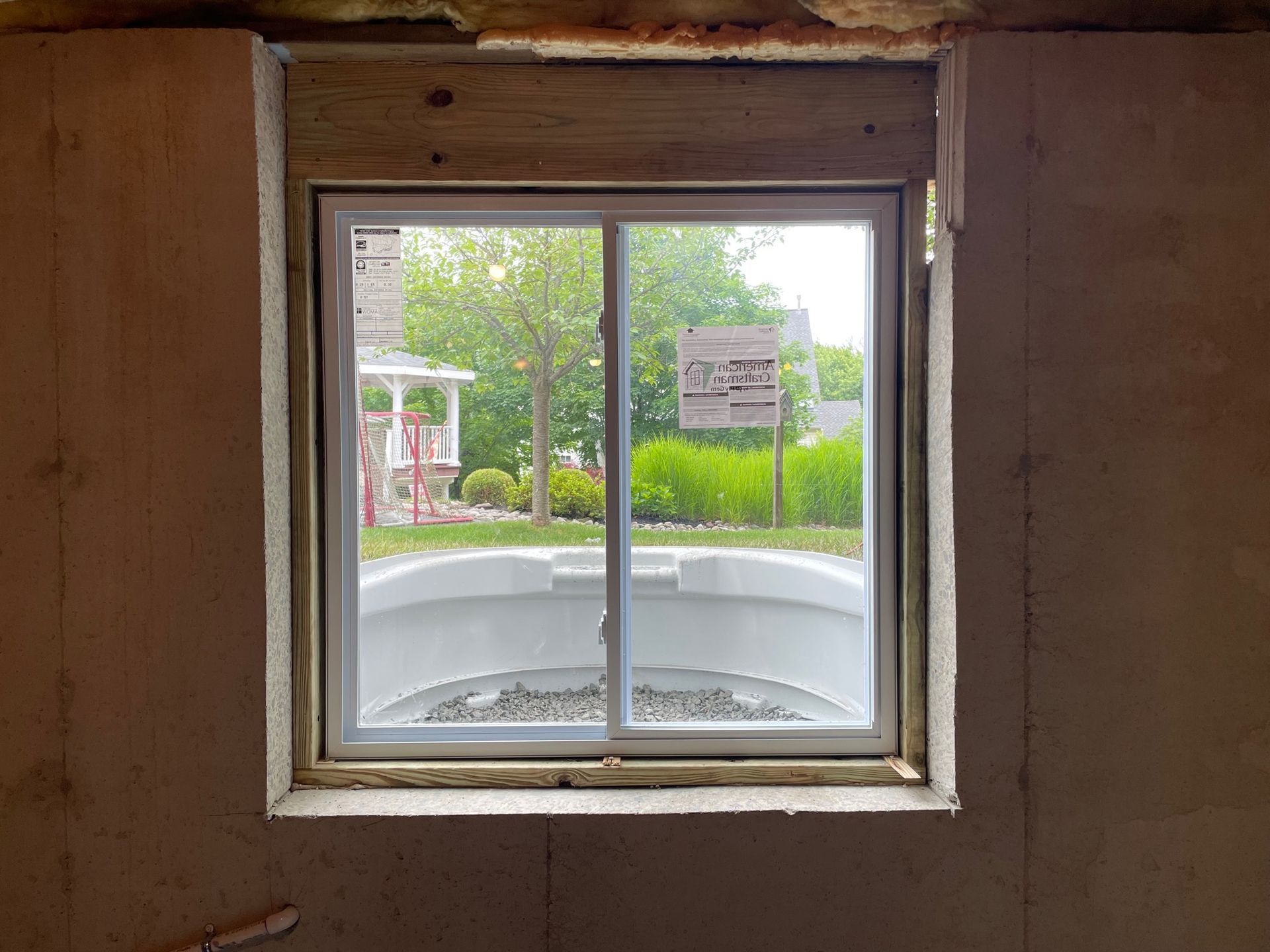 A window in a room with a view of a pool.